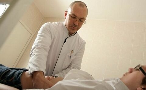 A doctor examining a patient with prostatitis